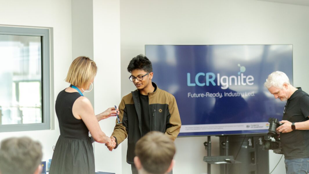 Male student receiving award