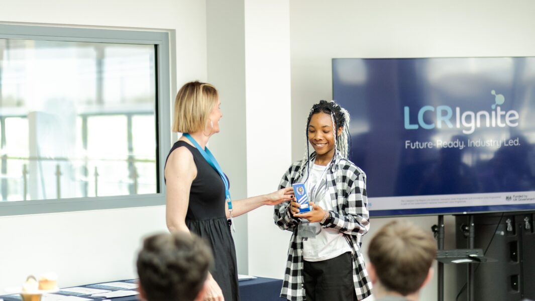 Female student receiving award