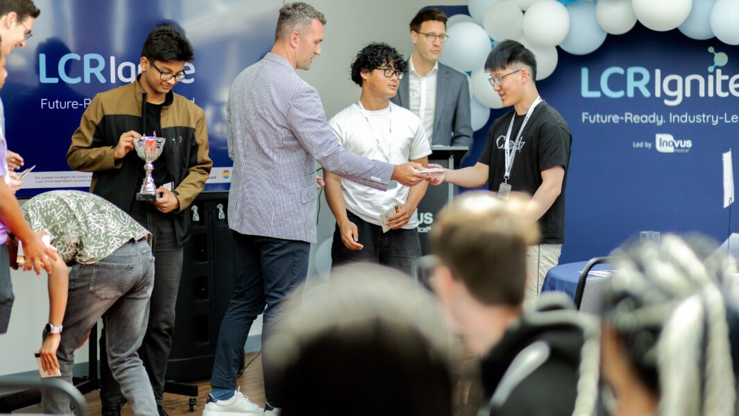 Group of male students receiving a trophy
