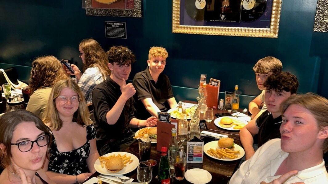 History students on a trip eating a meal in Rome