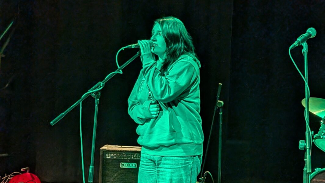 Female student singing in the Dalton Theatre