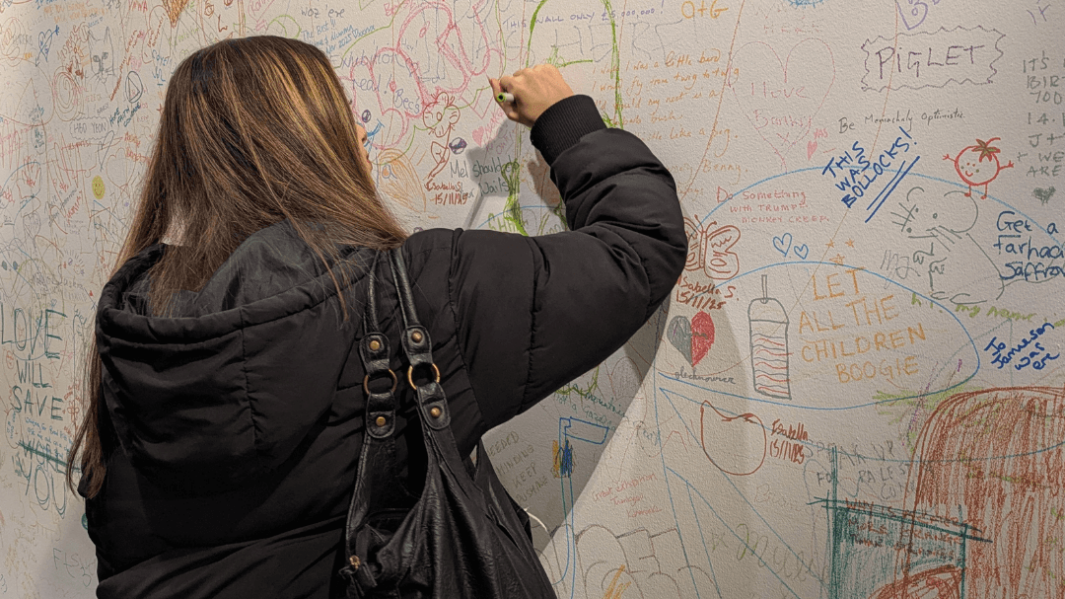 female student at an art gallery doing artwork