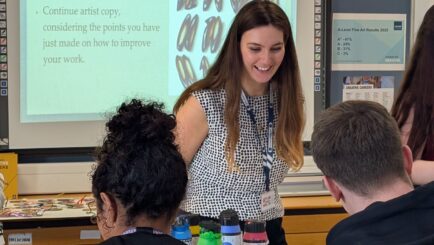 female teacher and two students in an art classroom