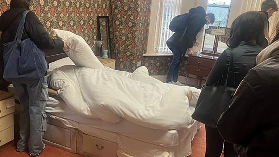 Group of Carmel students search in a simulated bedroom as part of Crime Scene Investigation experience at Edge Hill university.