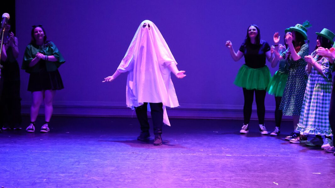 Student dressed as a ghost from Wizard of Oz with other students int the background