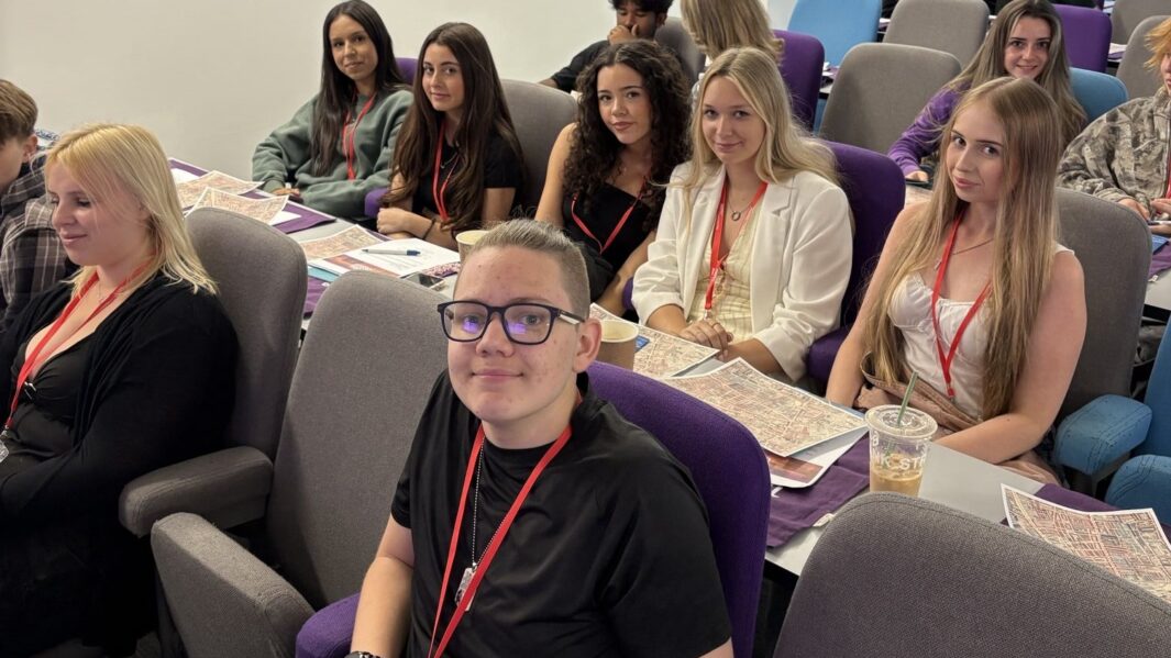A group of students say in a lecture theatre