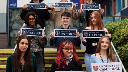 group of male and female students on the steps at the front of college