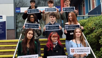 Group of students on stairs at front of college