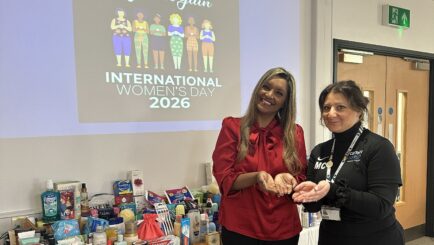 Photo of Manny Crooks and Shana Begum with a collection for IWD for the womens refuge