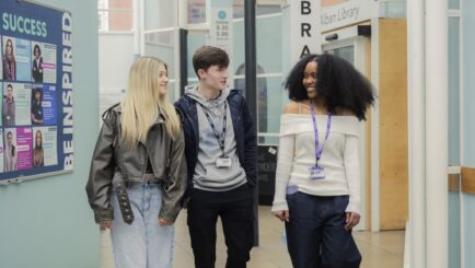 Group of students walking by the library