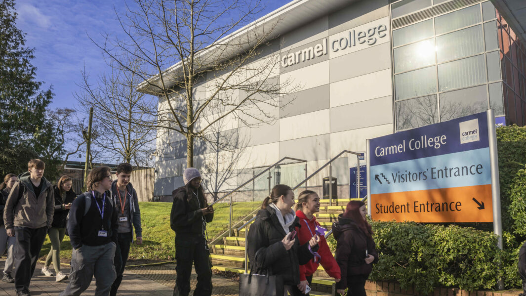 The front of carmel college with students entering