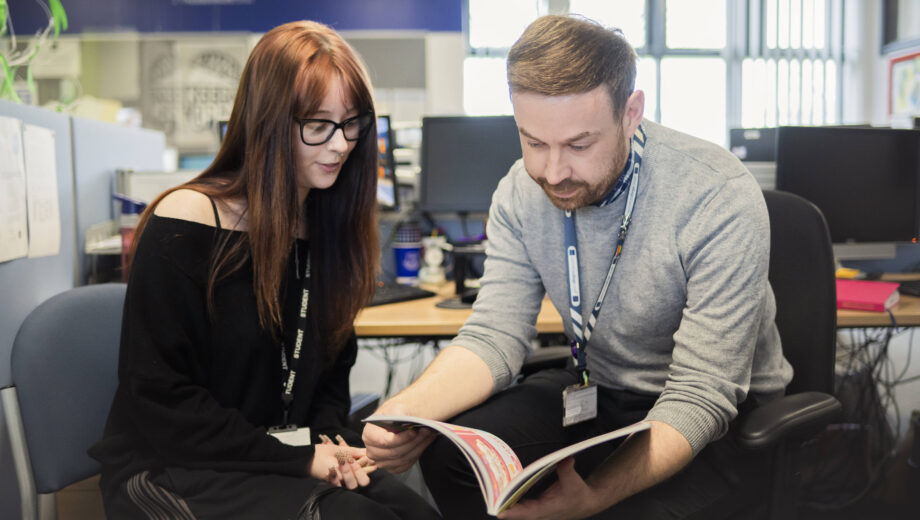 Male teacher and female student having one to one support