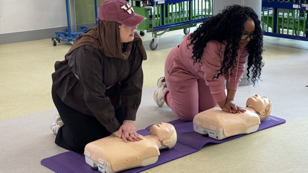 Two students practising CPR