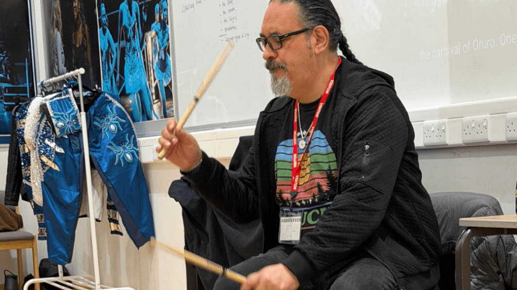 A man from Luma Creations playing drums in the dance studio