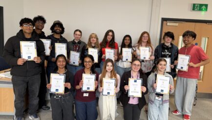 A large group of male and female students with the certificates