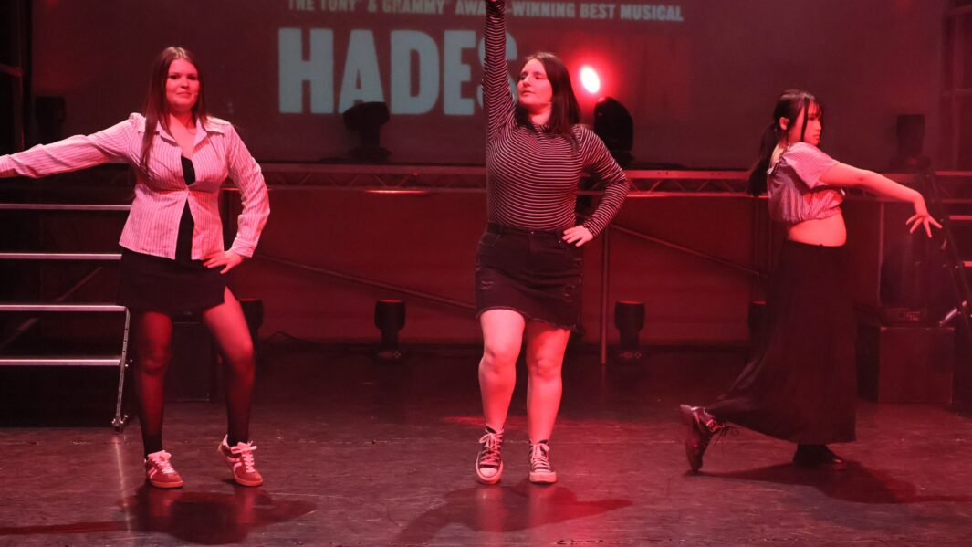 three girls dancing on stage