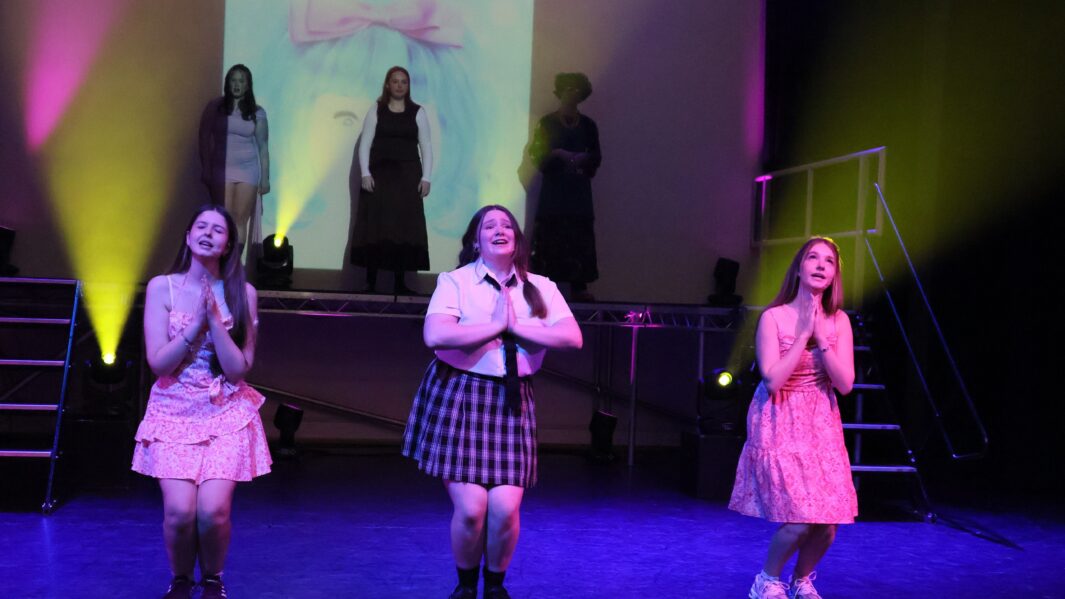Three girls on stage in the Dalton Theatre