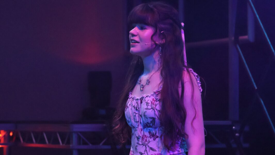 Girl singing on stage in the Dalton Theatre