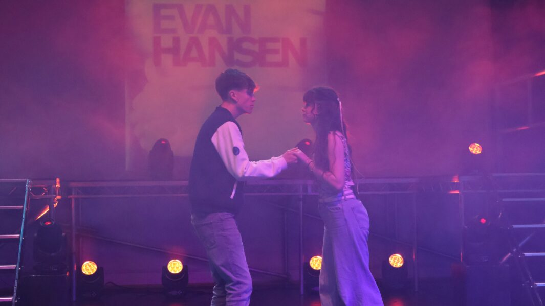 boy and girl singing on stage