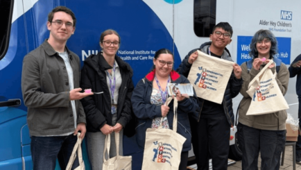 students outside NHS bus