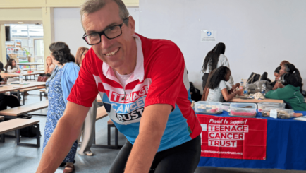 Simon on his bike cycling for teenage cancer trust