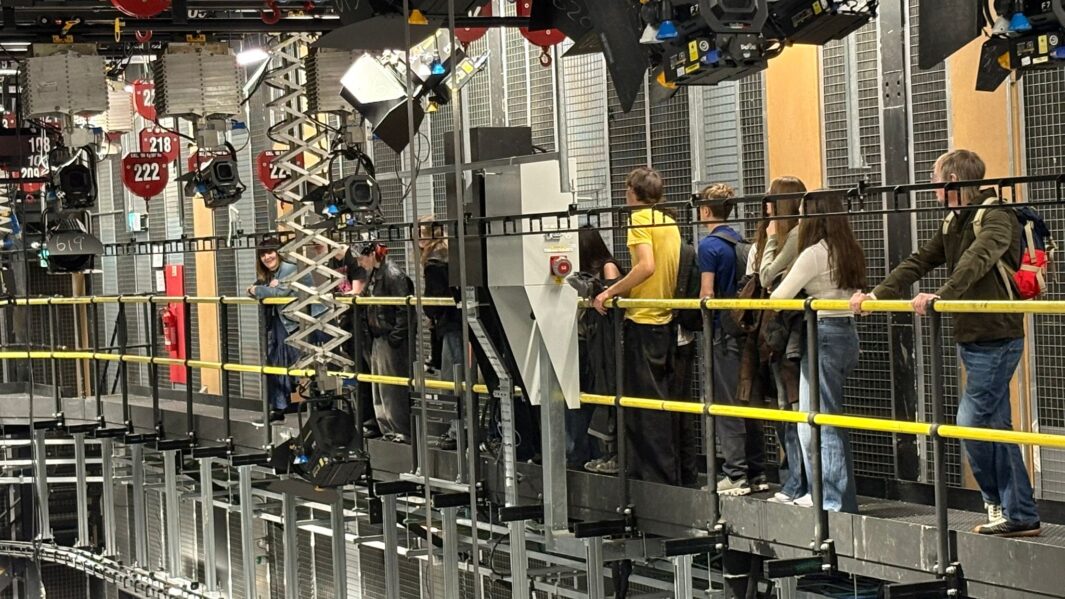 students in the filming studio looking at equipment
