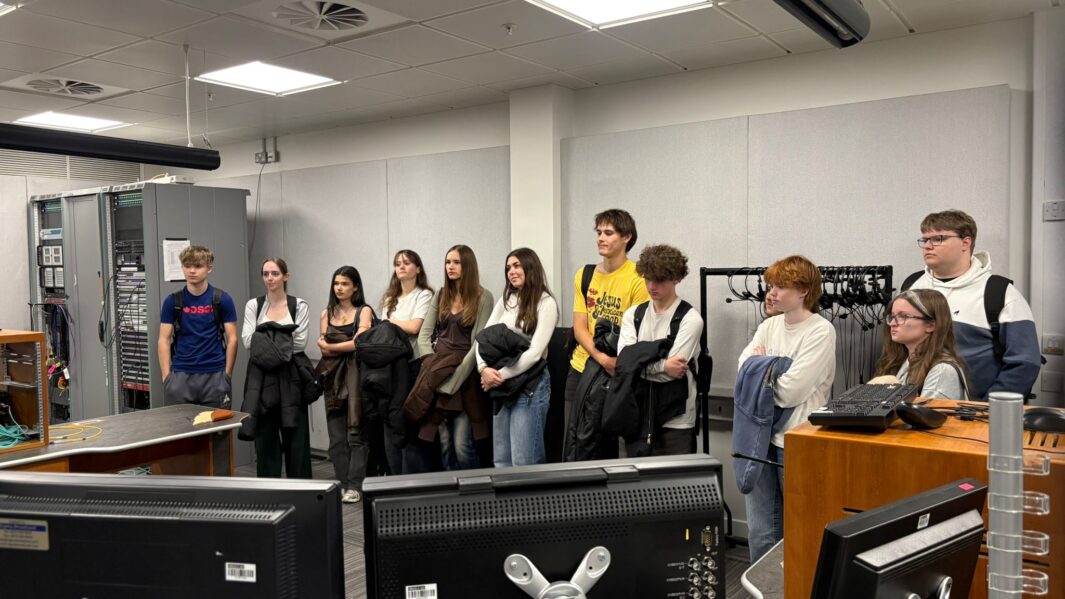 students in studio looking at equipment