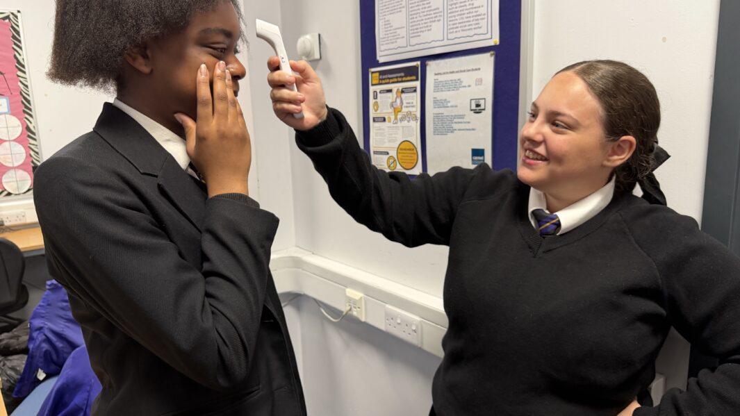 two girls in school uniform doing an activity