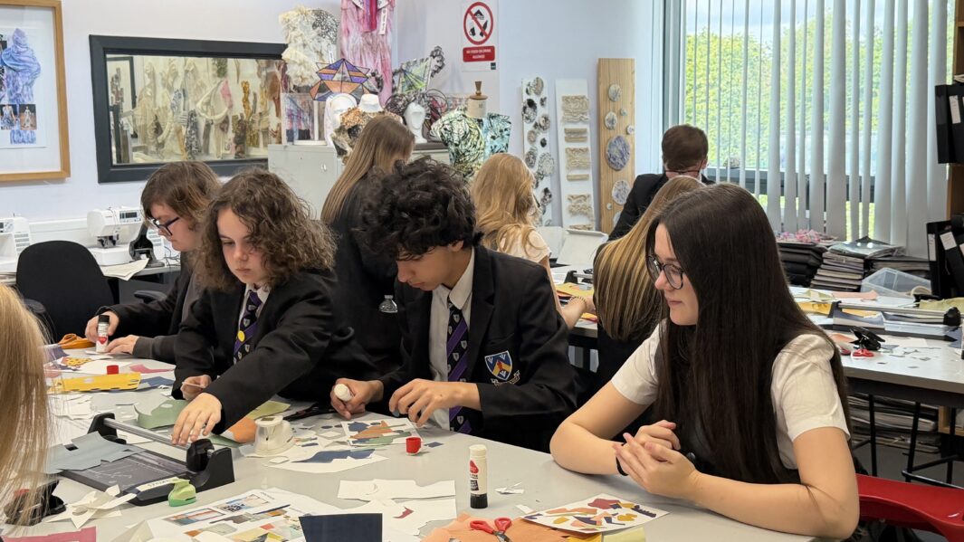 Students in school uniform working in an art class