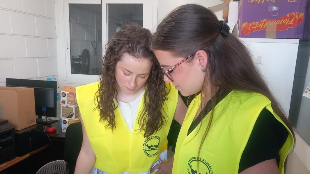 Two female students wearing hi vis jackers working