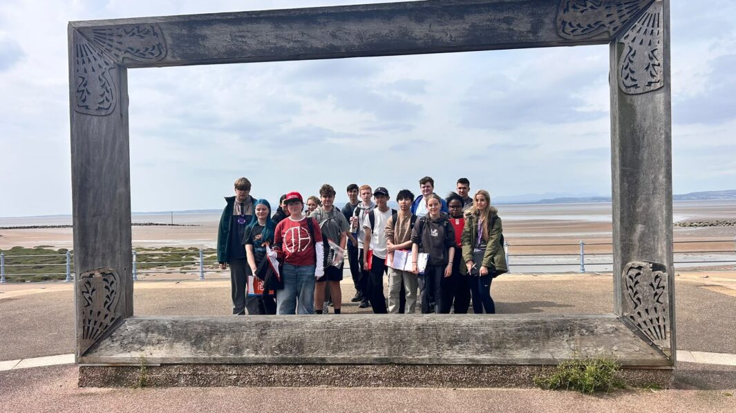 students stood on beach prom