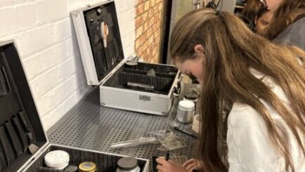 female student doing some forensic science at a desk