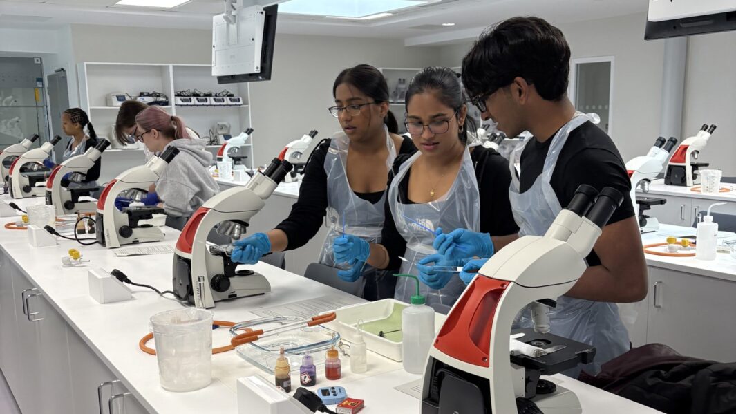 Students doing experiments in a lab at Edge Hill Uni wearing PPE