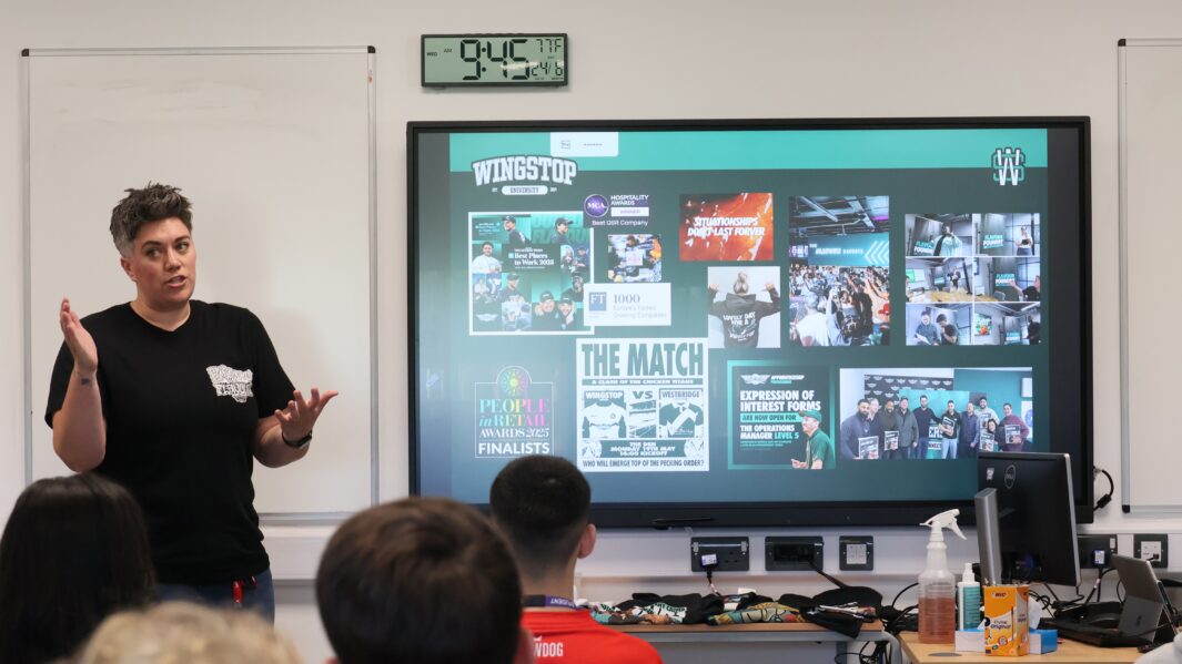 Faye speaking to a audience of students about her journey/career