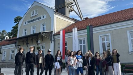 group of students stood outside a building in krakow