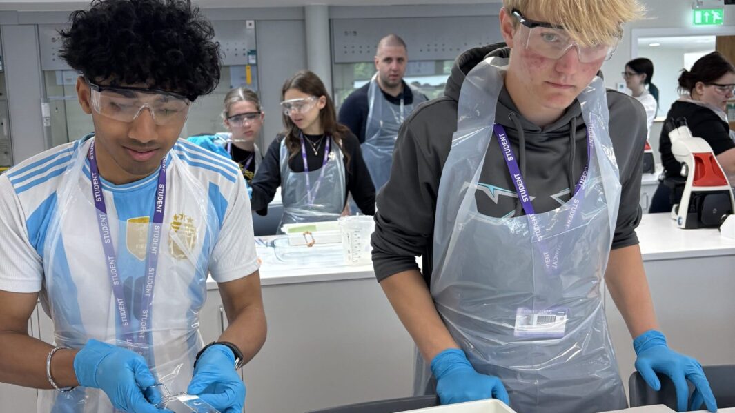 Students doing experiments in a lab at Edge Hill Uni wearing PPE
