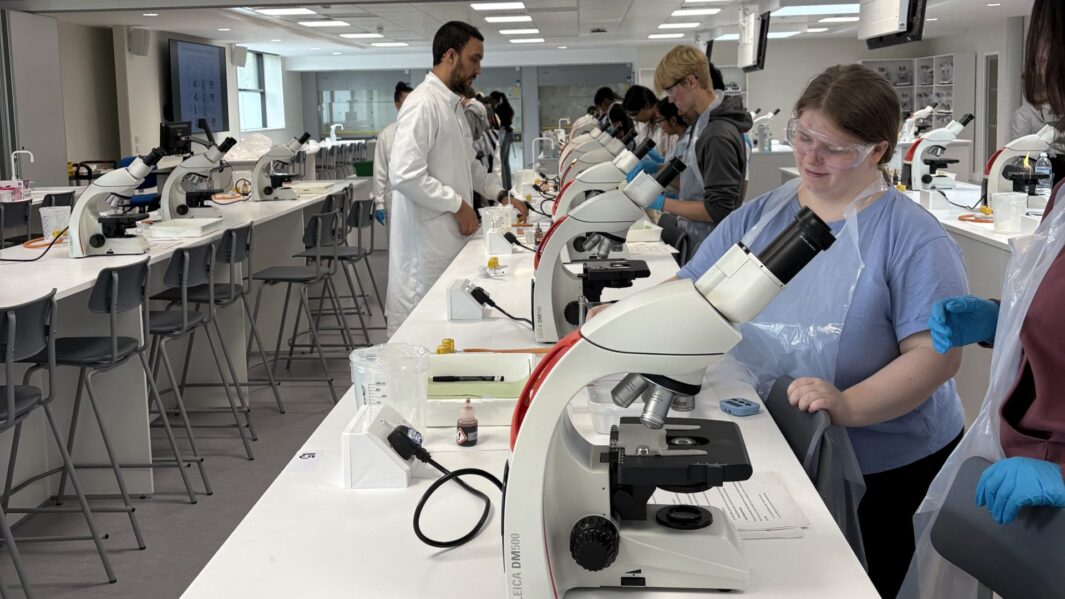 Students doing science experiments in a lab at Edge Hill Uni