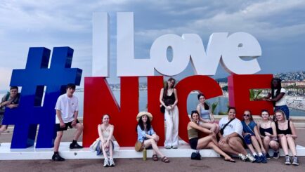 students pose with sign that says # i love nice