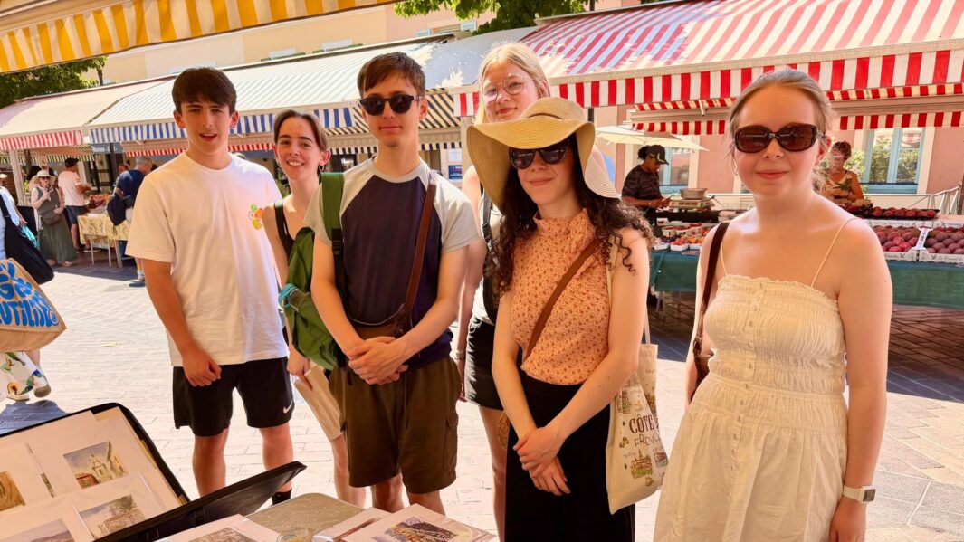 students looking through a market in Nice