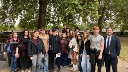 a group of students stood with MP David Baines